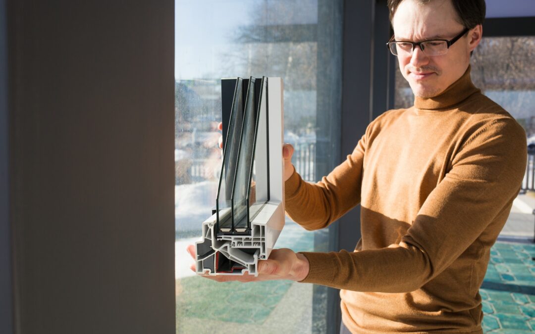 male architect engineer shows sample of double-glazed window for glazing modern glass houses